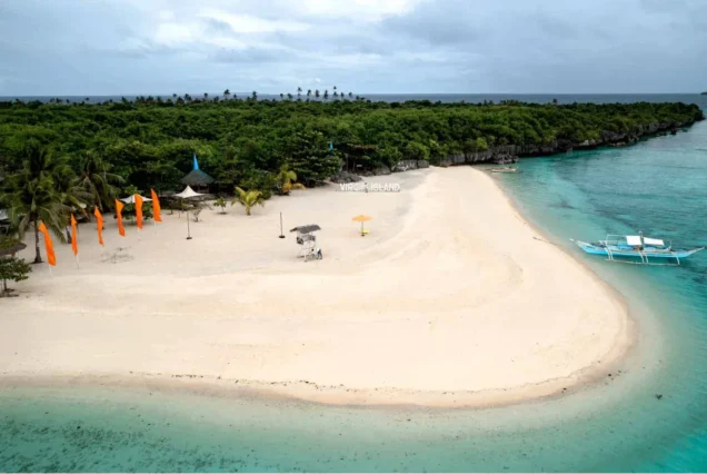 Kota Beach in Bantayan Island, Cebu, featuring white sand, clear blue waters, and tropical scenery.