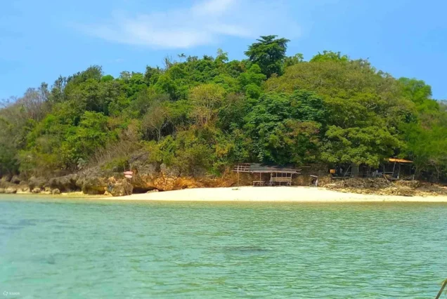Ave Maria Islet in Guimaras, featuring a small rocky islet surrounded by clear blue waters and scenic coastal views.