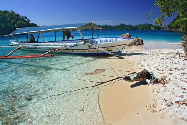 Guimaras island-hopping boat cruising through the clear waters and scenic coastal islands of Guimaras.
