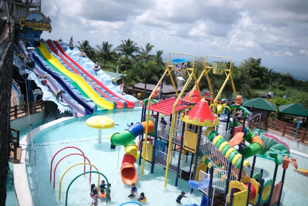 Campuestohan Highland Resort featuring colorful water slides, a children’s water play area, and tropical mountain scenery.