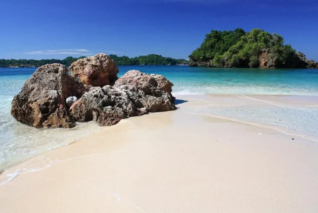 Ave Maria Islet in Guimaras, featuring a small rocky islet surrounded by clear blue waters and scenic coastal views.