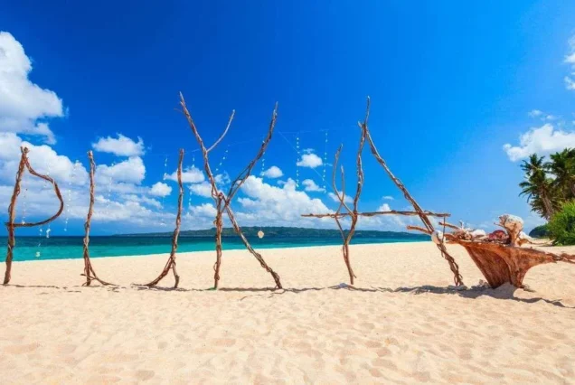 Puka Beach in Boracay, Aklan, featuring white sand, clear blue waters, and lush tropical surroundings.