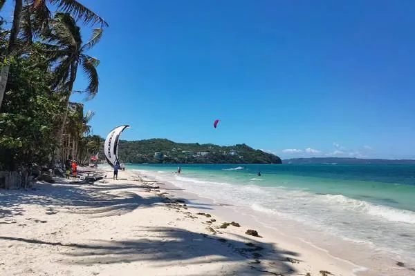 Scenic view of Boracay Island featuring white sand, turquoise waters, and tropical beach scenery.