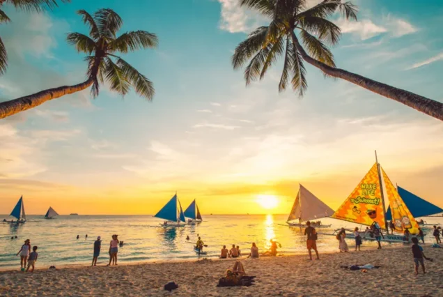 Stunning sunset over White Beach in Boracay, Aklan, with golden-orange skies reflecting across the calm tropical waters.